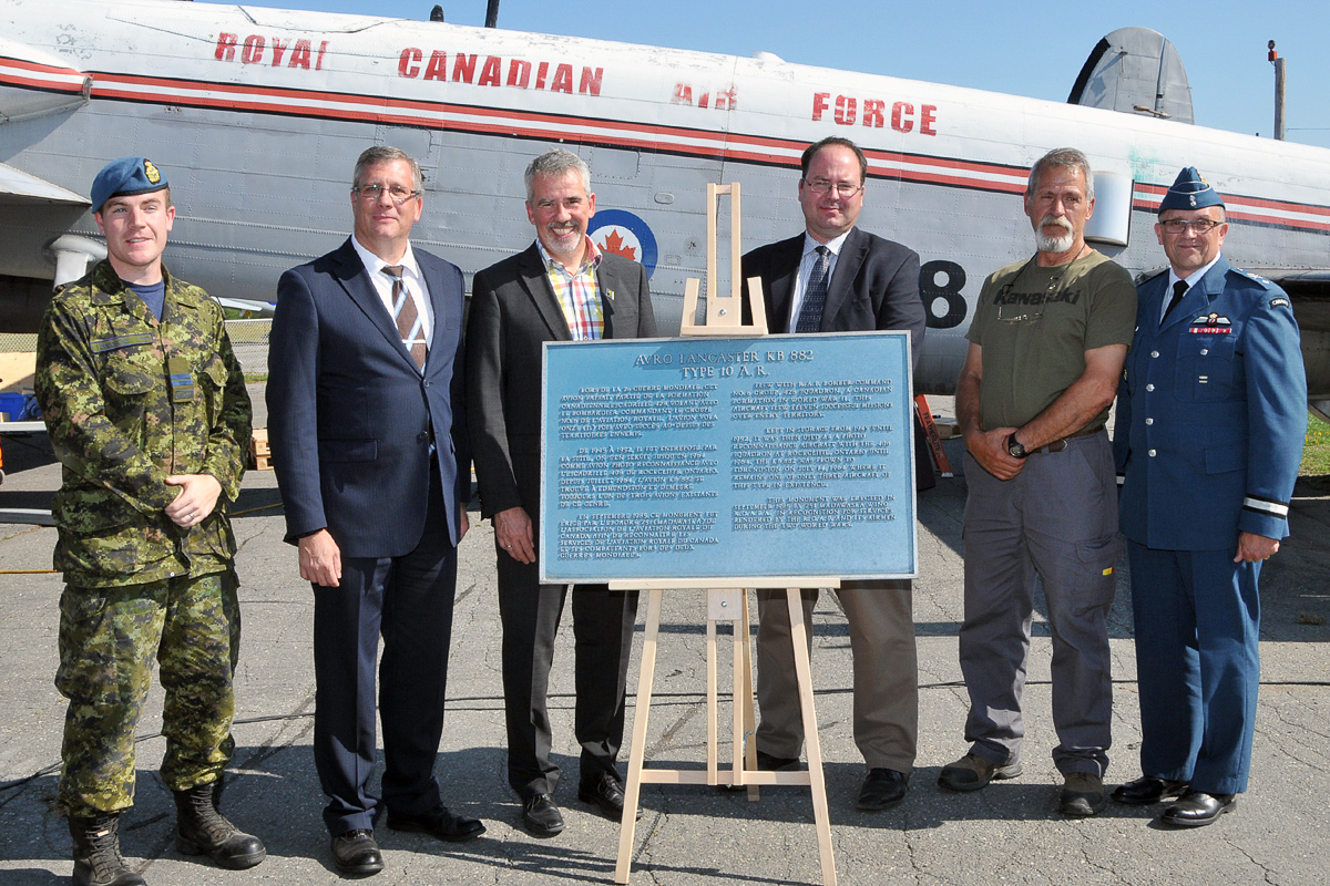 Gathered around the plaque presented by the Edmundston mayor to the National Air Force Museum are (from left) Captain Jamie Boudreau of ATESS, heading the team dismantling KB882; Kevin Windsor, museum curator; Mayor Cyrille Simard; Dr. Richard Mayne, the RCAF’s chief historian; Mike Joly, head of the restoration shop at the museum; and Brigadier-General Scott Howden of the RCAF. (Photo by Warrant Officer Fran Gaudet DND)