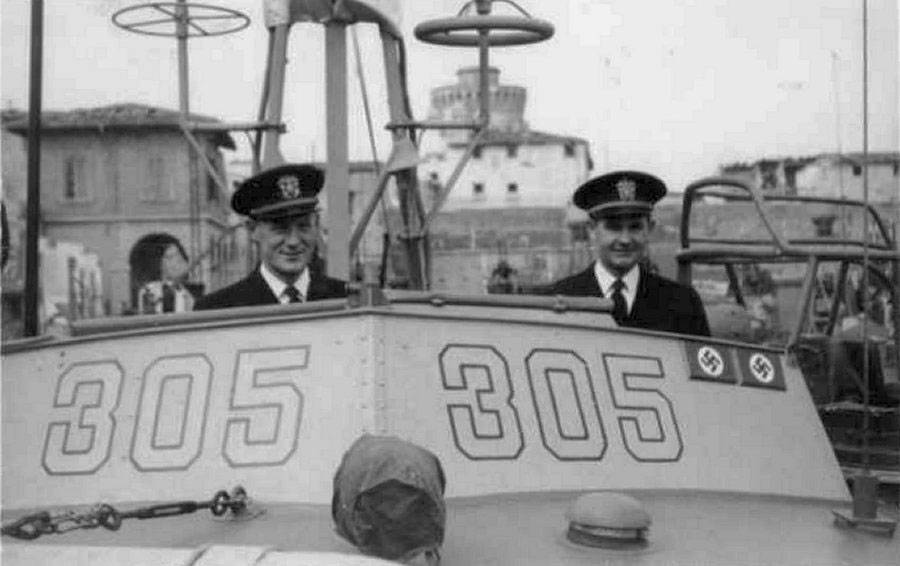 Ensign Bleeker Morse (left) and Lieutenant Junior Grade Allan Purdy on the bridge of PT-305 in Leghorn (Livorno), Italy, on March 16, 1945. The “kill plaques” on the chart house signify the two enemy craft sunk by PT-305 to that date. Gift of Joseph Brannan.